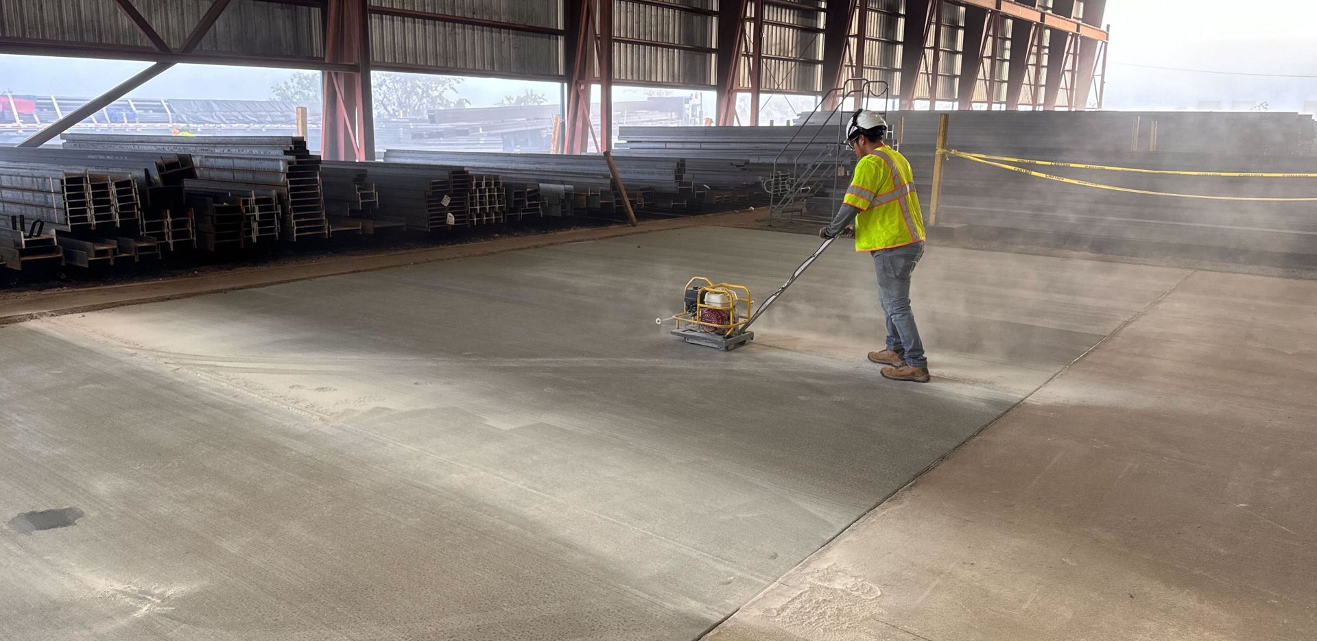 Concrete finisher smoothing a freshly poured slab in Tampa, Florida